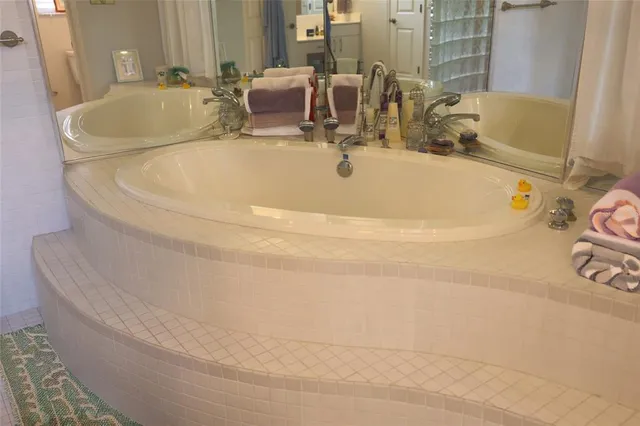 a white bath tub sitting next to a white sink