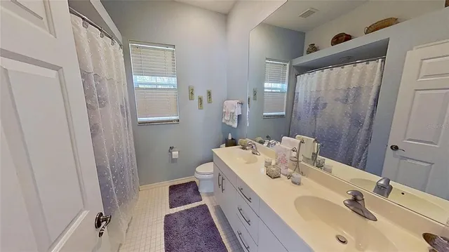 a bathroom with a double vanity sink and mirror