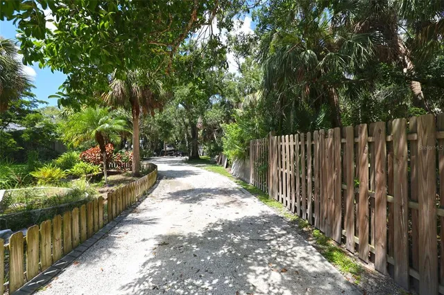 a view of a pathway with a wrought fence
