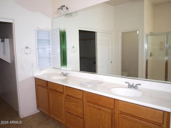 a bathroom with a granite countertop sink double and mirror
