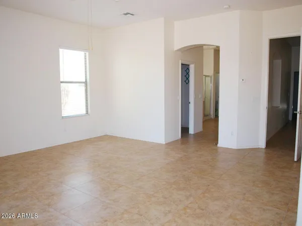 an empty room with windows and closet