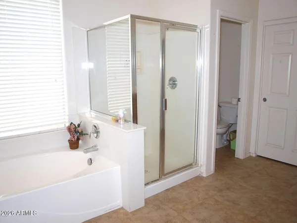 a bathroom with a tub shower and a sink