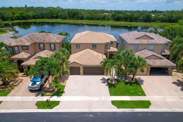 an aerial view of a house with outdoor space lake view and lake view