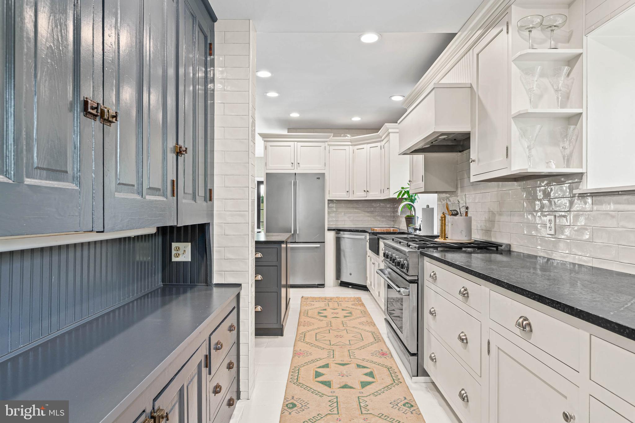 119 Cambria Court Wayne, PA 19087 - Photo 14 of 52 a kitchen with stainless steel appliances granite countertop a refrigerator a sink dishwasher a stove and white cabinets with wooden floor