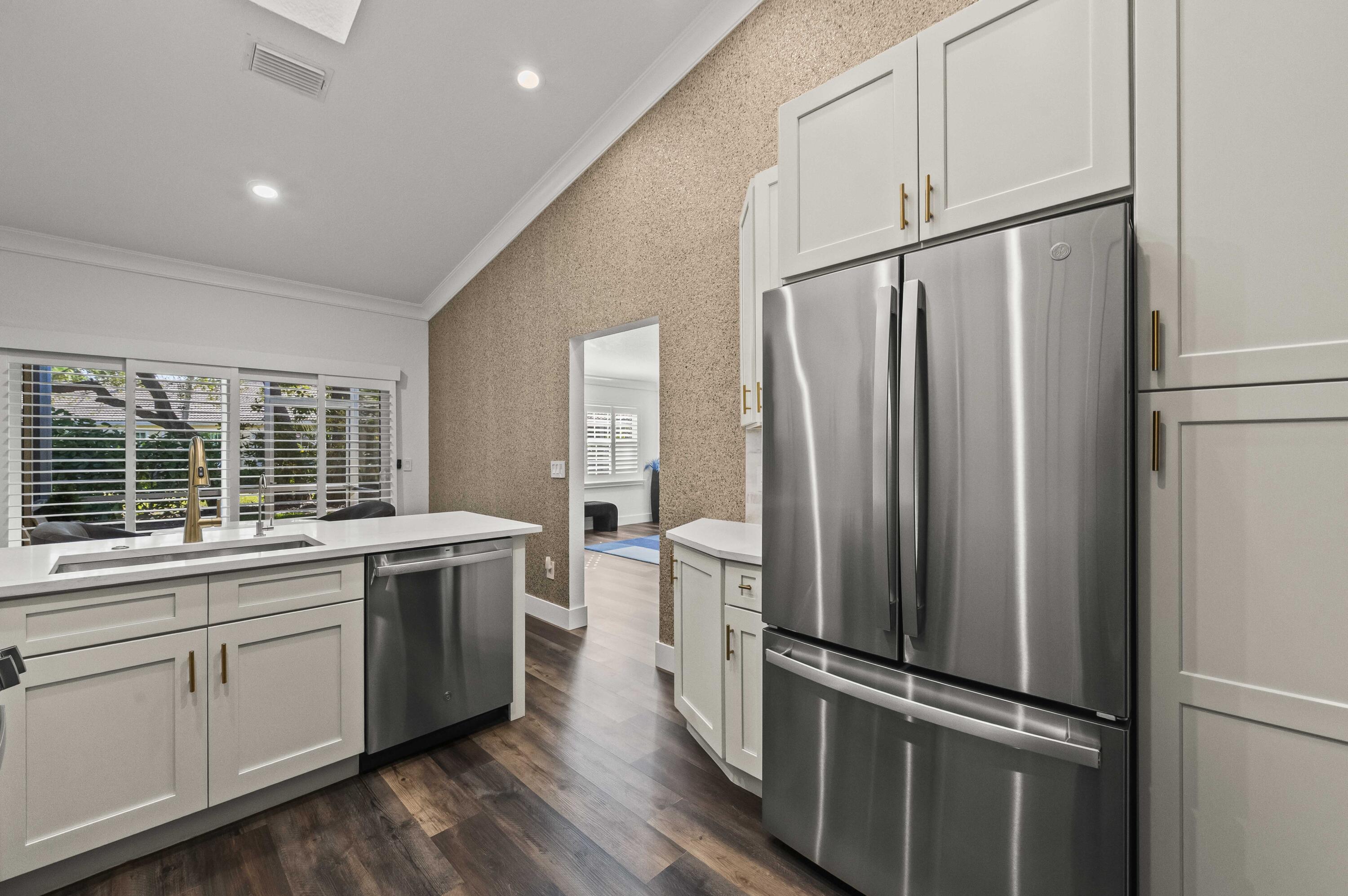 17257 Boca Club Boulevard, Unit 4 Boca Raton, FL 33487 - Photo 12 of 35 a kitchen with stainless steel appliances a refrigerator stove and sink