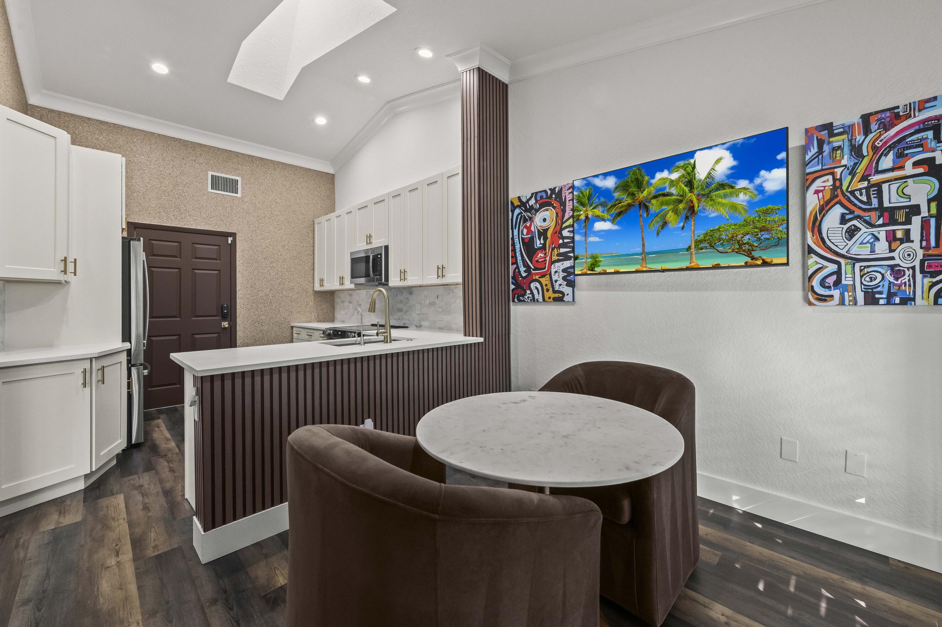 17257 Boca Club Boulevard, Unit 4 Boca Raton, FL 33487 - Photo 13 of 35 a kitchen with stainless steel appliances granite countertop a sink and a refrigerator