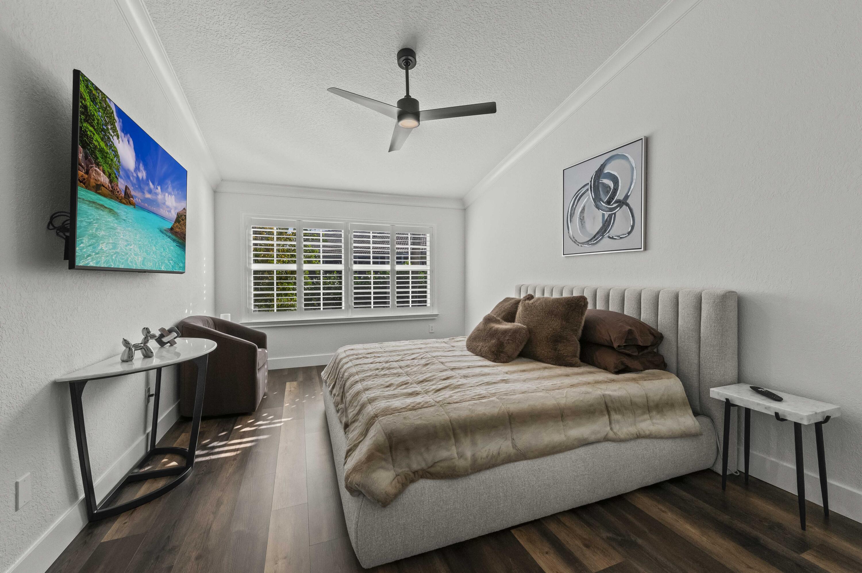 17257 Boca Club Boulevard, Unit 4 Boca Raton, FL 33487 - Photo 20 of 35 a bedroom with a bed and wooden floor