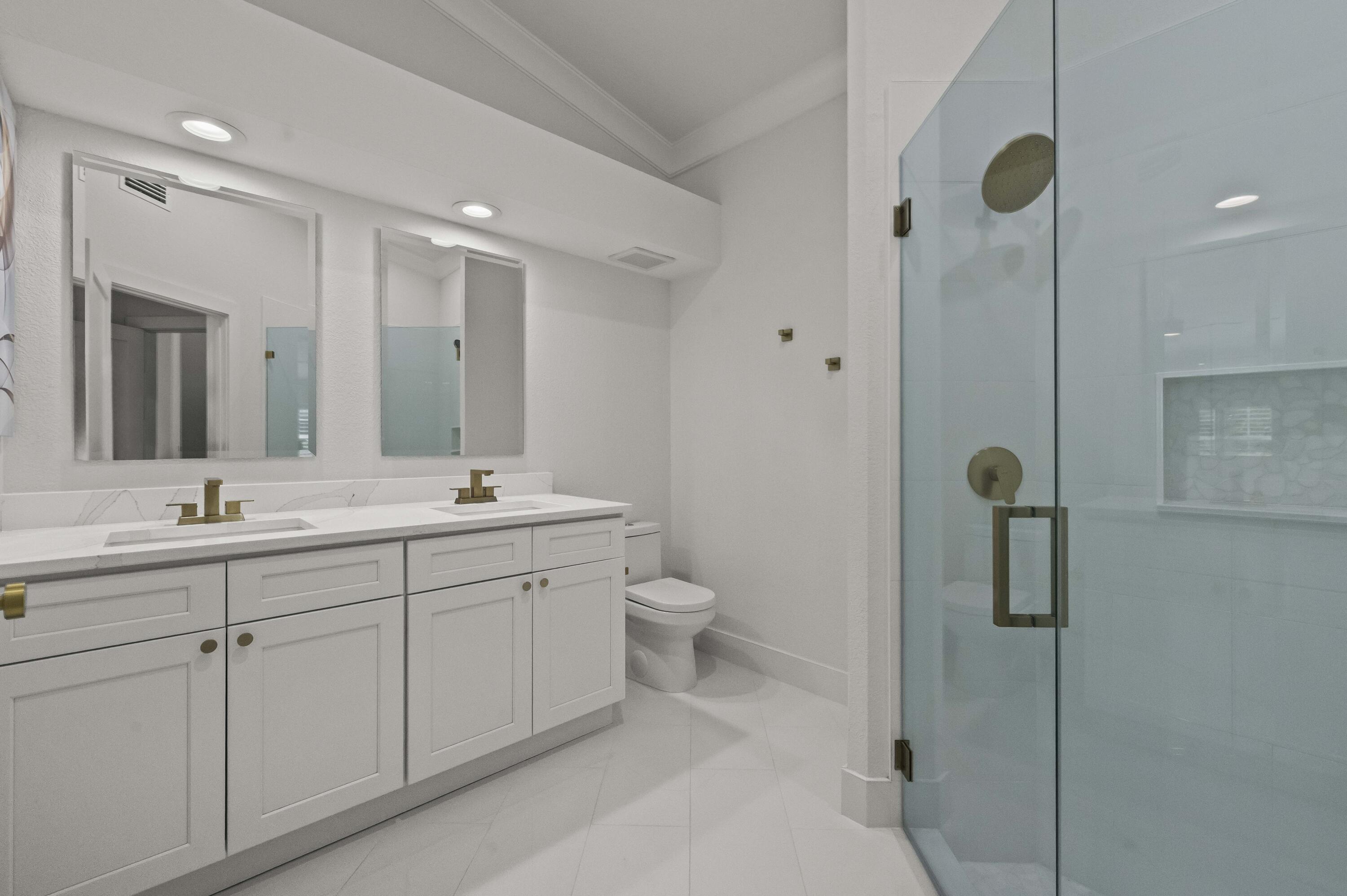 17257 Boca Club Boulevard, Unit 4 Boca Raton, FL 33487 - Photo 21 of 35 a bathroom with a double vanity sink mirror and shower