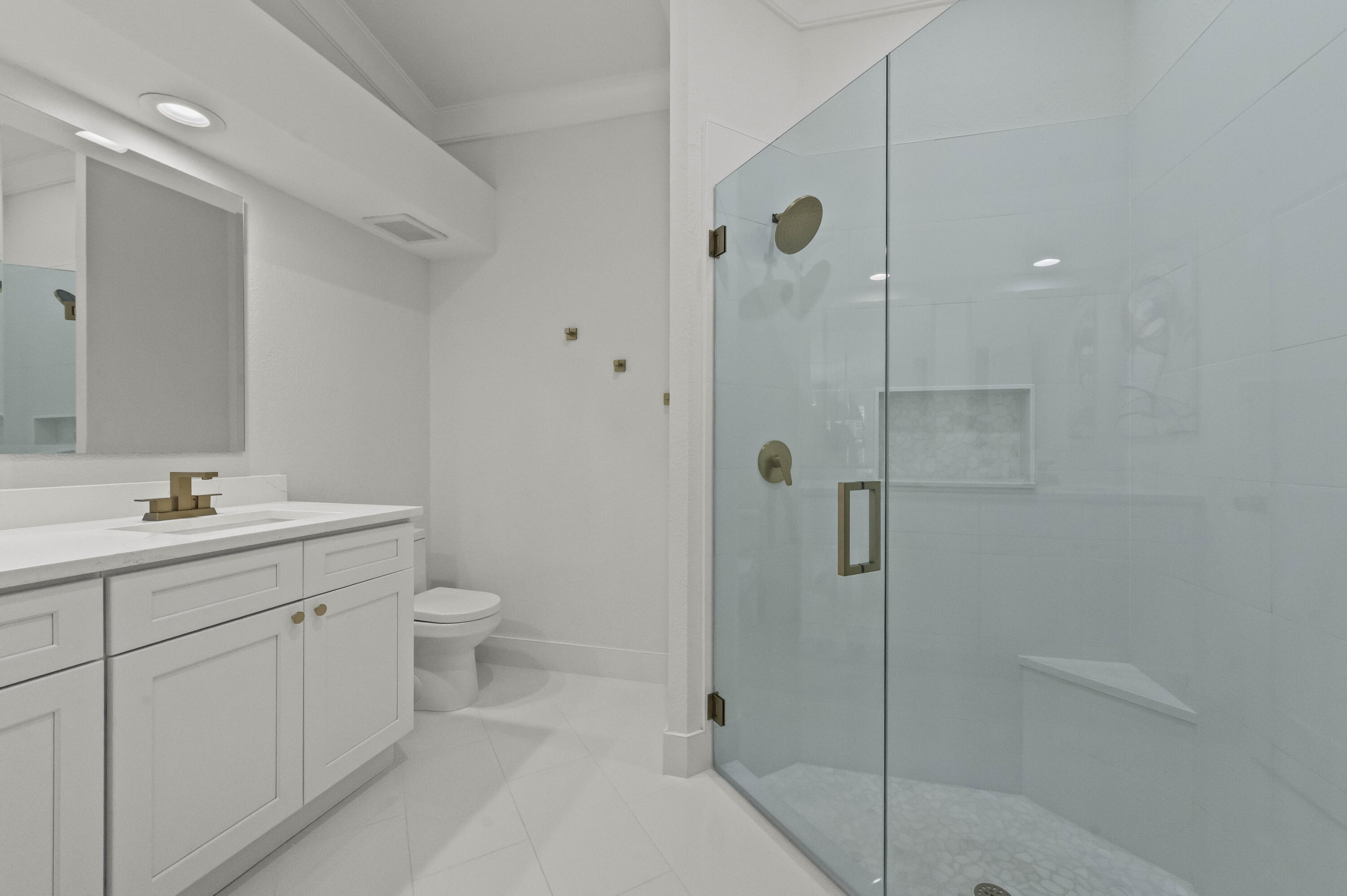 17257 Boca Club Boulevard, Unit 4 Boca Raton, FL 33487 - Photo 22 of 35 a bathroom with a shower sink vanity and toilet