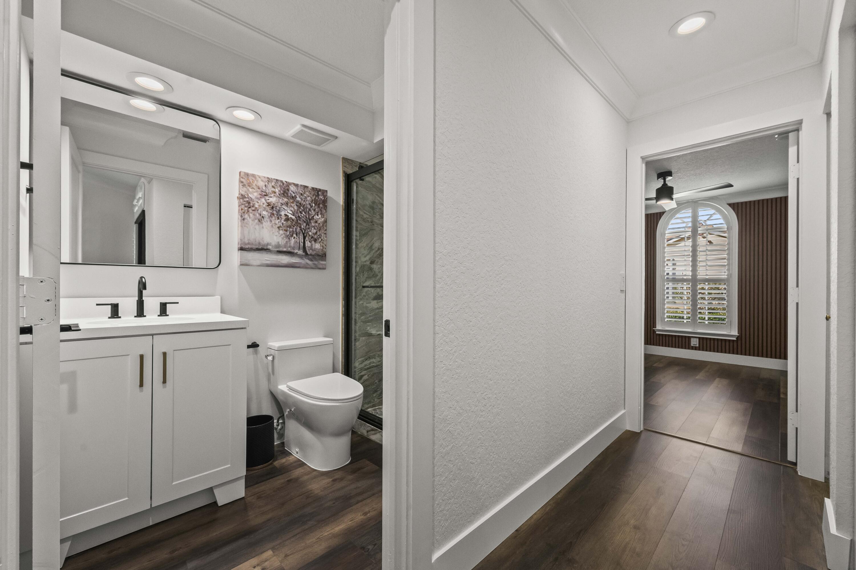 17257 Boca Club Boulevard, Unit 4 Boca Raton, FL 33487 - Photo 26 of 35 a bathroom with a toilet sink and mirror