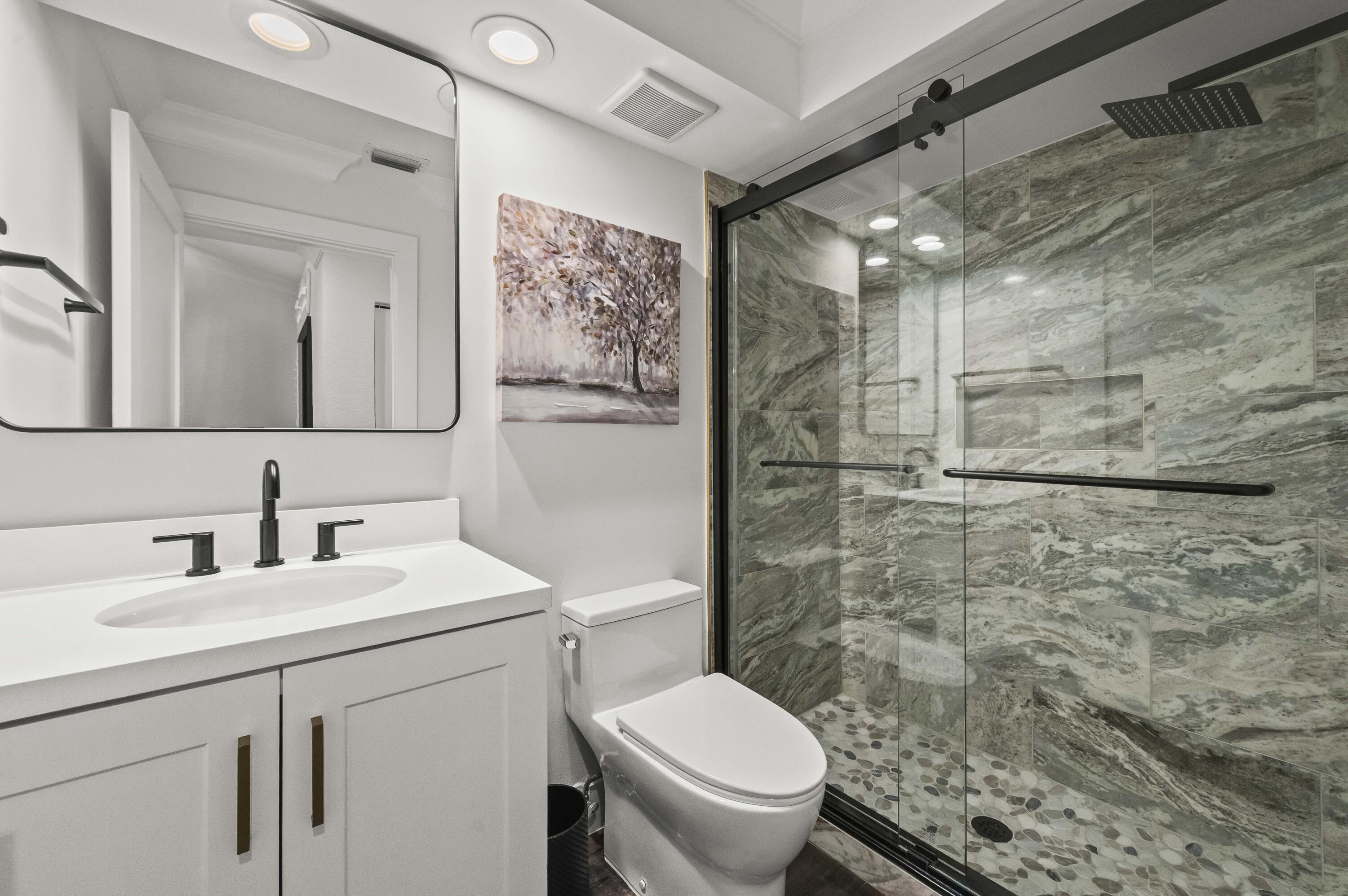 17257 Boca Club Boulevard, Unit 4 Boca Raton, FL 33487 - Photo 27 of 35 a bathroom with a toilet sink and shower