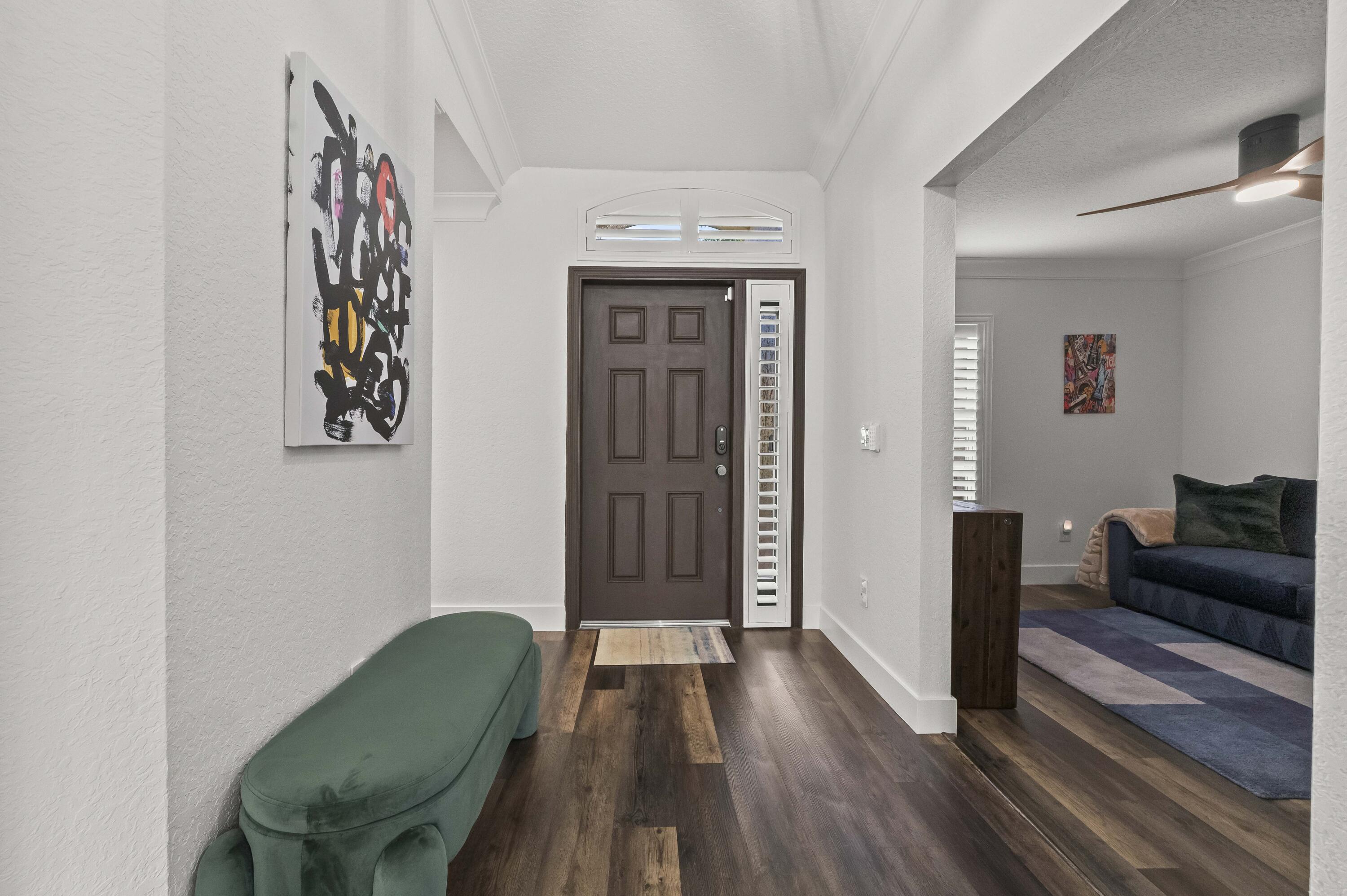 17257 Boca Club Boulevard, Unit 4 Boca Raton, FL 33487 - Photo 28 of 35 a view of a livingroom with furniture and wooden floor