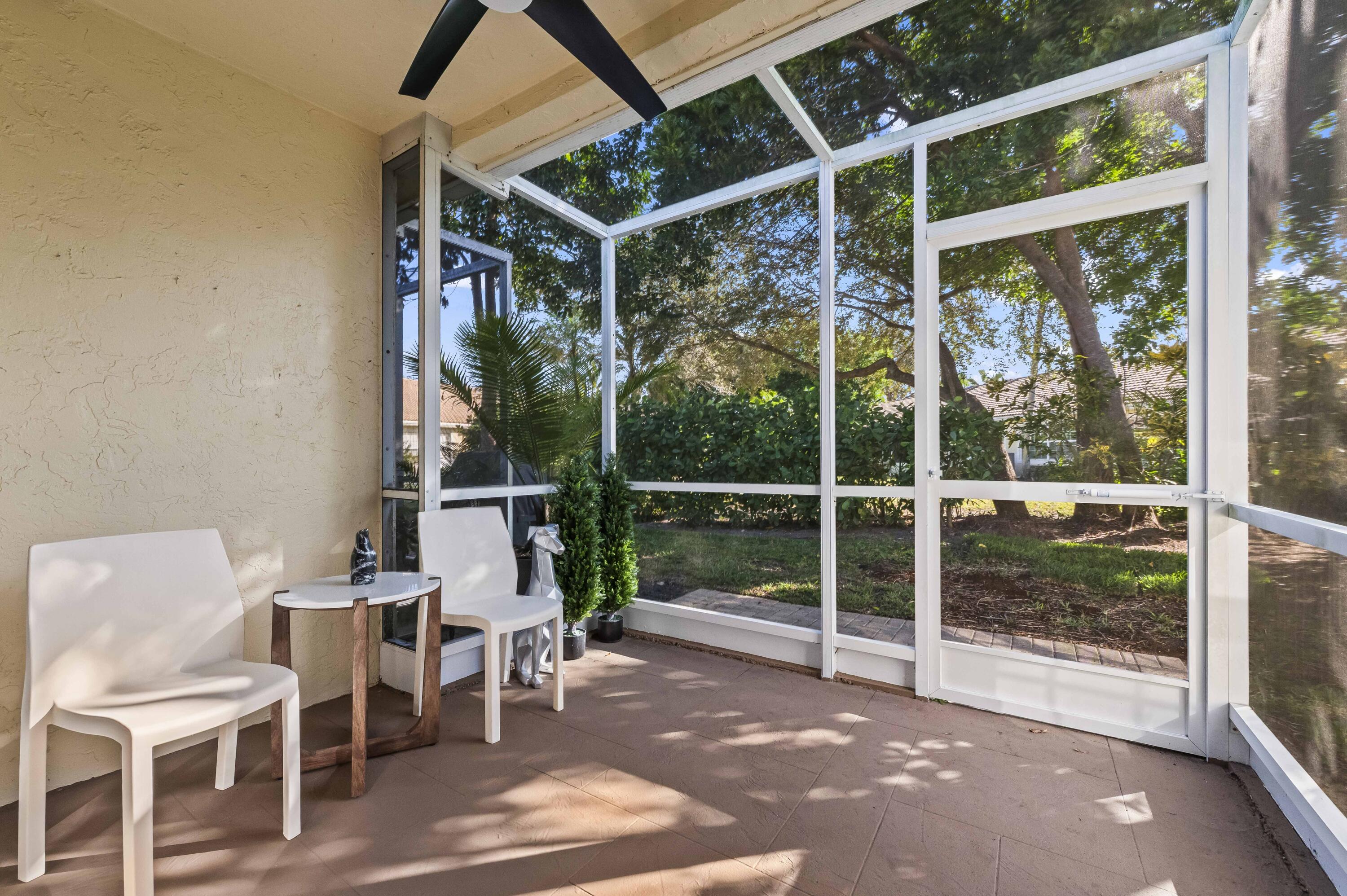 17257 Boca Club Boulevard, Unit 4 Boca Raton, FL 33487 - Photo 29 of 35 a view of a patio with table and chairs and wooden floor