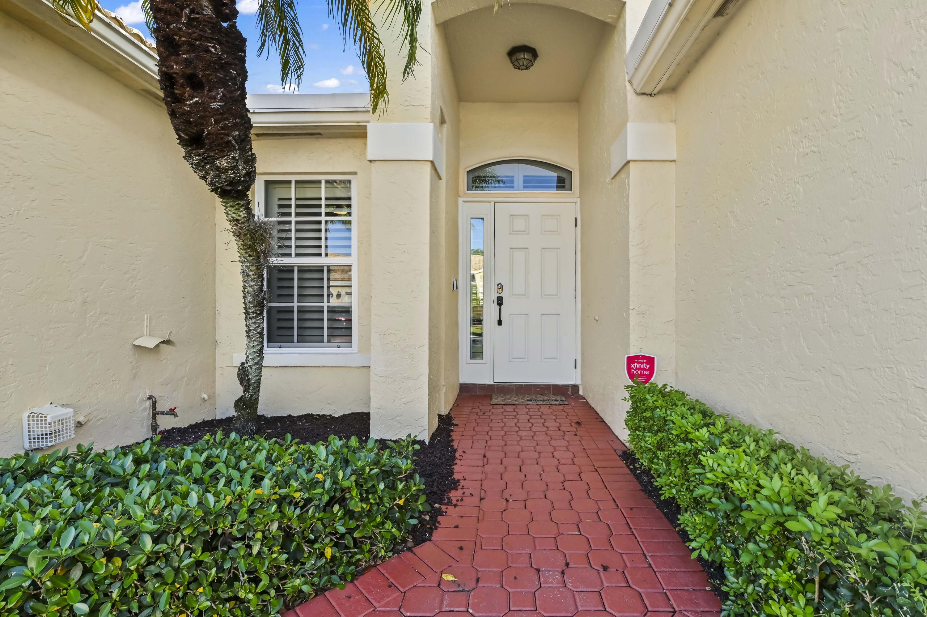 17257 Boca Club Boulevard, Unit 4 Boca Raton, FL 33487 - Photo 3 of 35 a front view of a house with a yard
