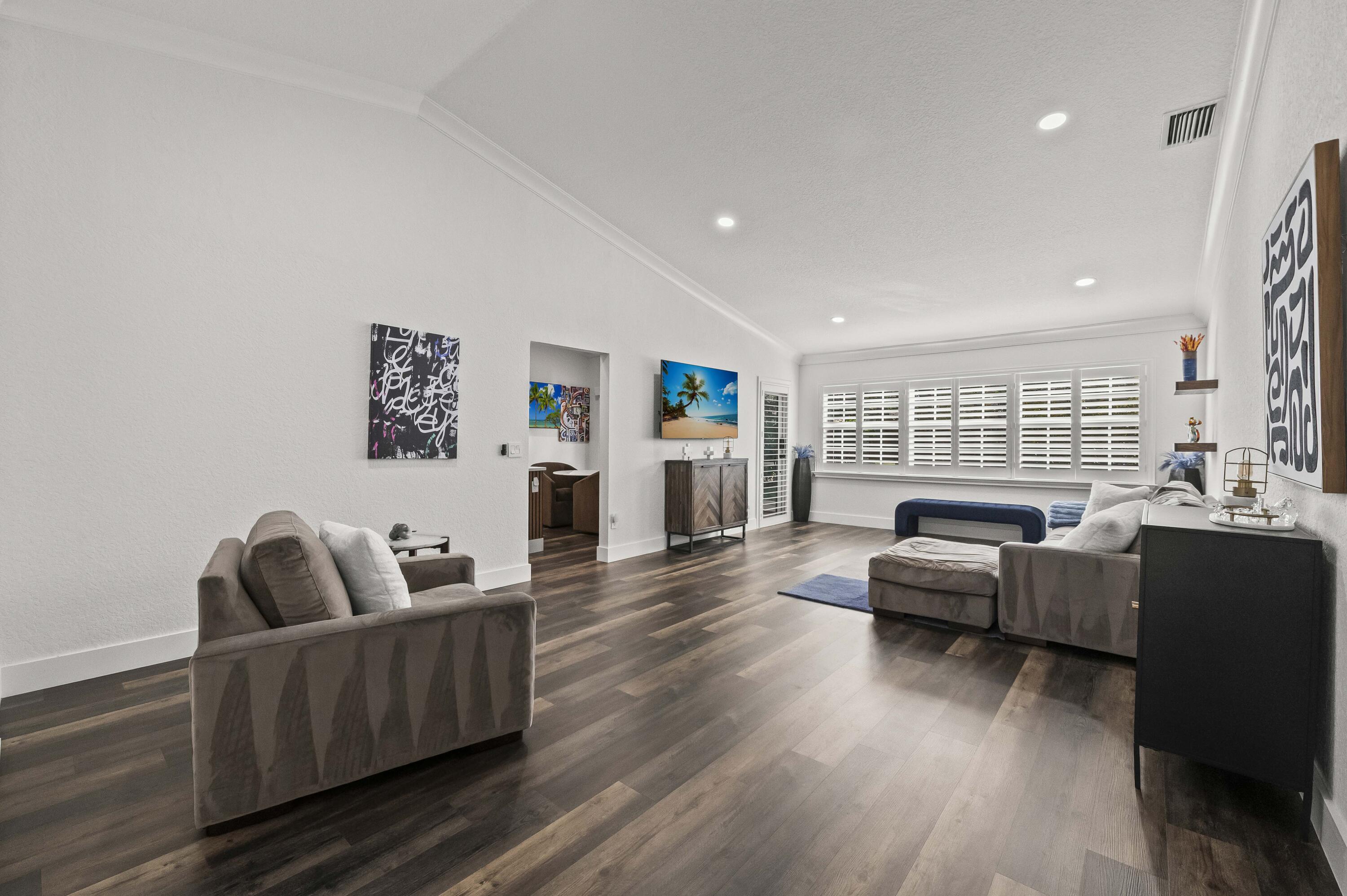 17257 Boca Club Boulevard, Unit 4 Boca Raton, FL 33487 - Photo 5 of 35 a living room with furniture and a large window