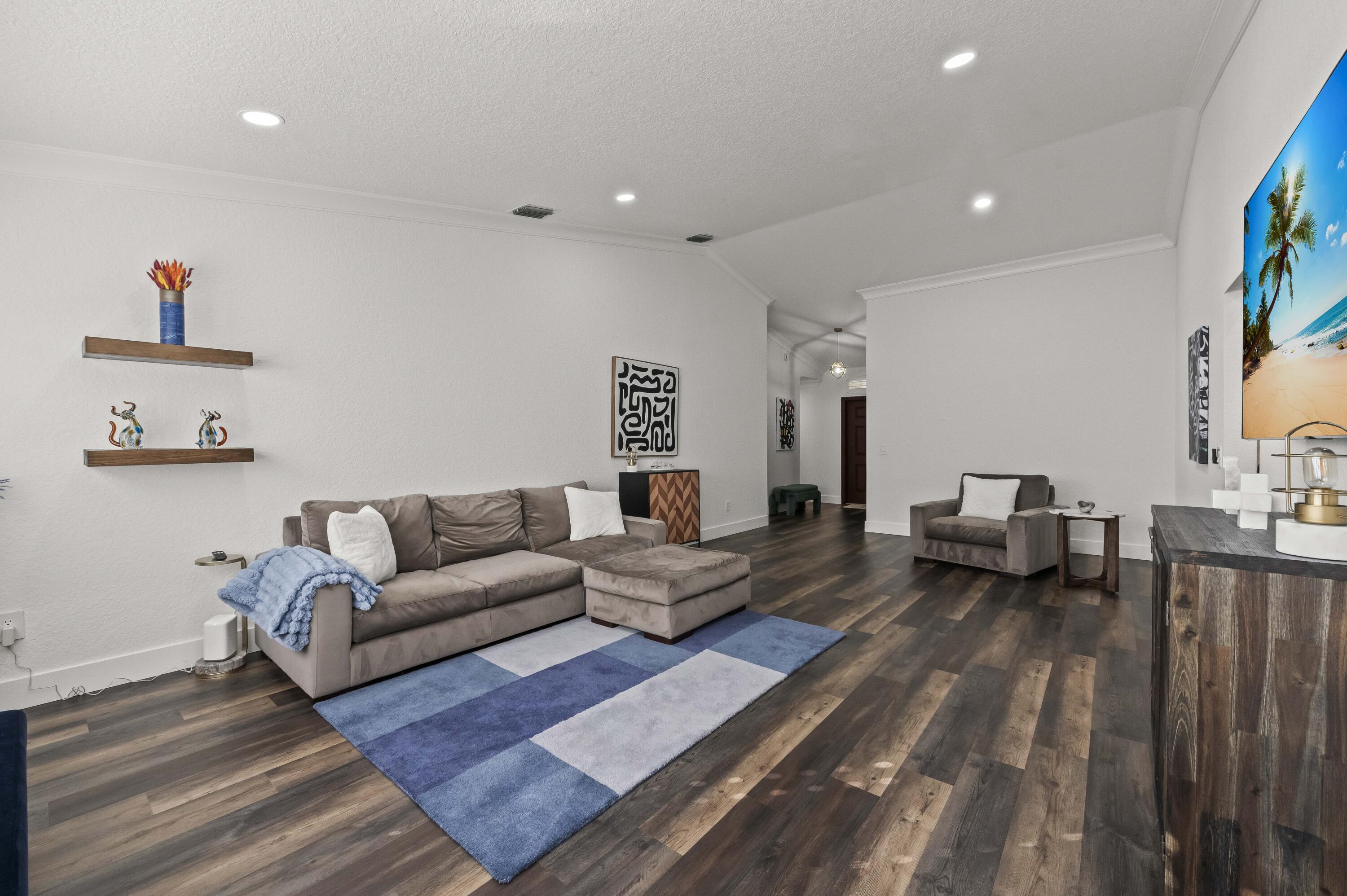 17257 Boca Club Boulevard, Unit 4 Boca Raton, FL 33487 - Photo 7 of 35 a living room with furniture and a couch