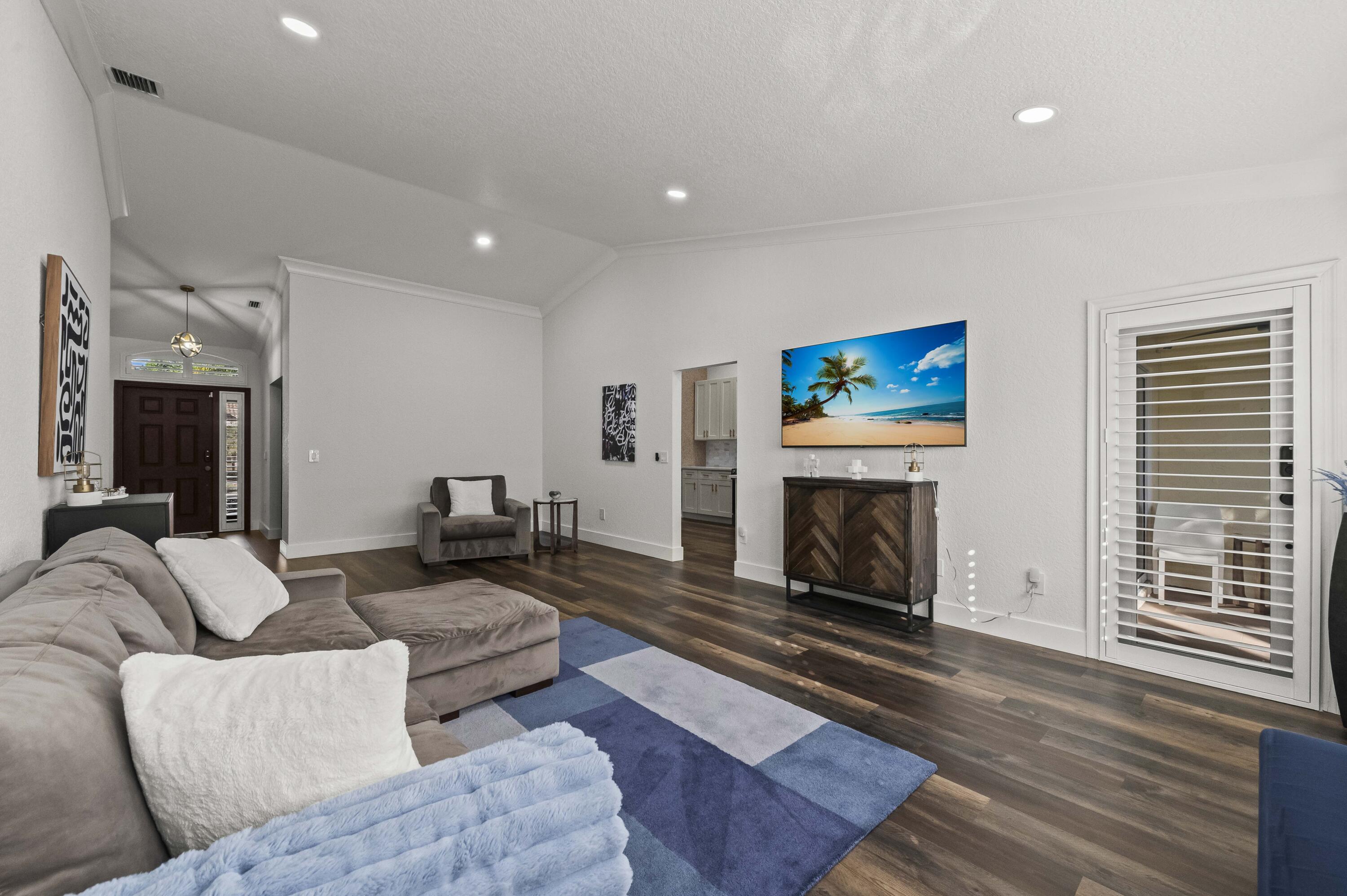 17257 Boca Club Boulevard, Unit 4 Boca Raton, FL 33487 - Photo 8 of 35 a living room with furniture a fireplace and a floor to ceiling window