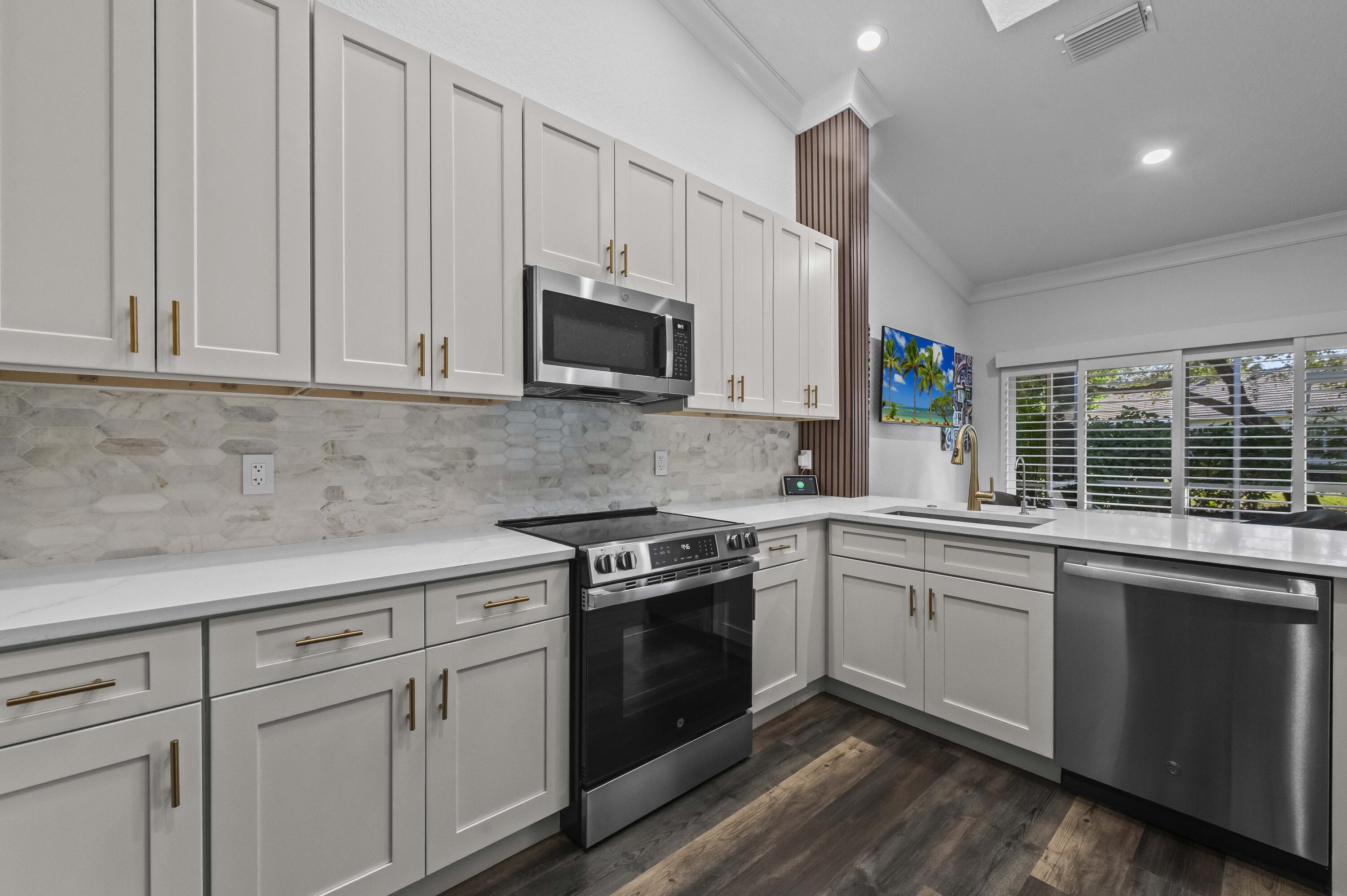 17257 Boca Club Boulevard, Unit 4 Boca Raton, FL 33487 - Photo 10 of 35 a kitchen with appliances a sink and cabinets