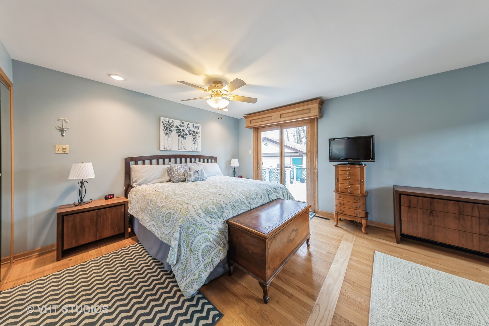 1423 Burr Oak Road Homewood, IL 60430 - Photo 5 of 12 a bedroom with a large bed a chandelier and dresser