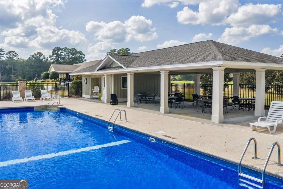 215 Falcon Crest Warner Robins, GA 31088 - Photo 11 of 18 a view of a house with pool and chairs
