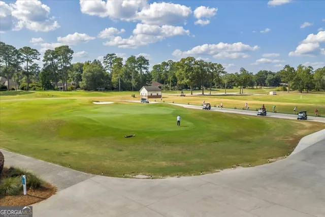a swimming pool with outdoor seating and yard