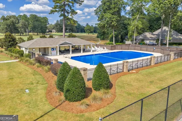 a view of a house with pool and chairs