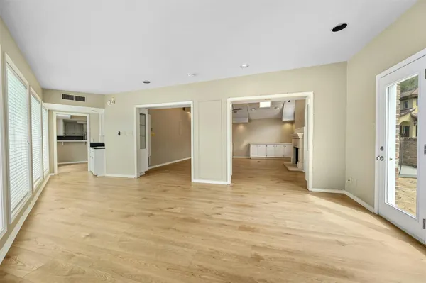 wooden floor in an empty room with a bathroom