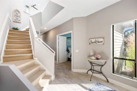 a spacious bedroom with a bed and large windows