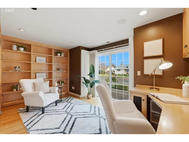 a living room with furniture a rug a lamp and a large window