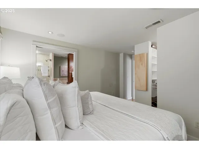 a bedroom with a bed and a mirror