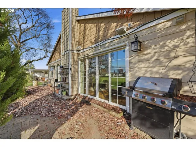 a backyard of a house with barbeque oven