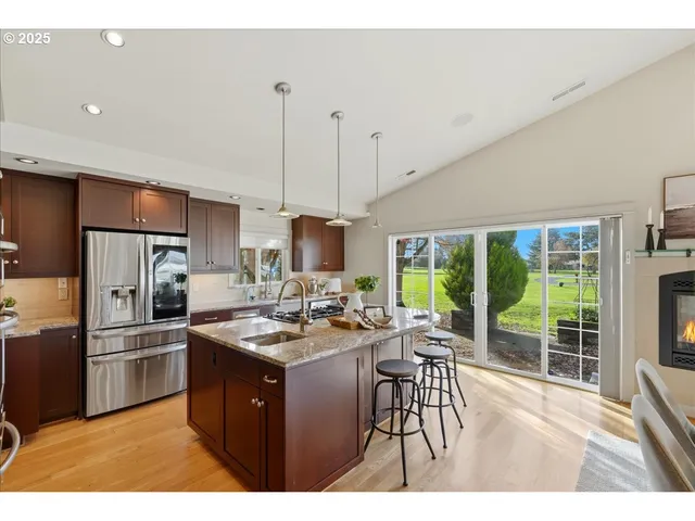 a kitchen with sink a stove and refrigerator