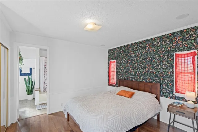 a bedroom with a bed and a potted plant