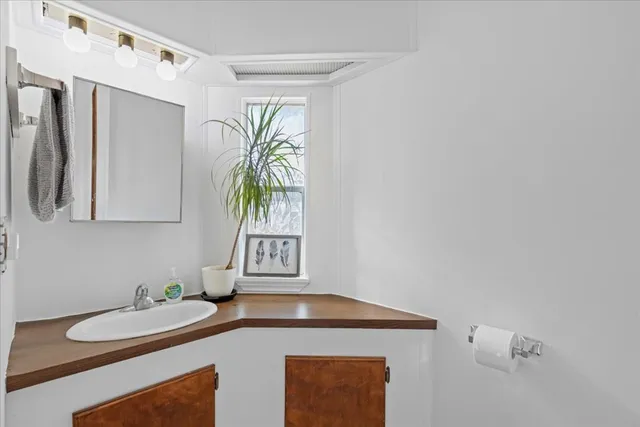 a kitchen with a sink a counter top space and cabinets
