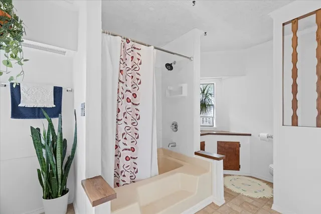 a view of a patio with table and chairs under an umbrella