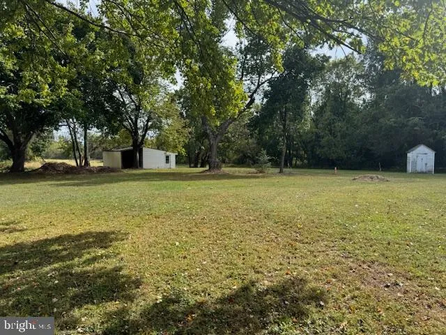 a view of a field with an trees
