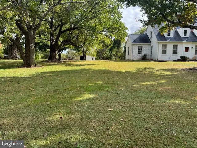 a house view with swimming pool in front of it