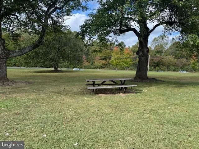 a view of outdoor space with deck and yard