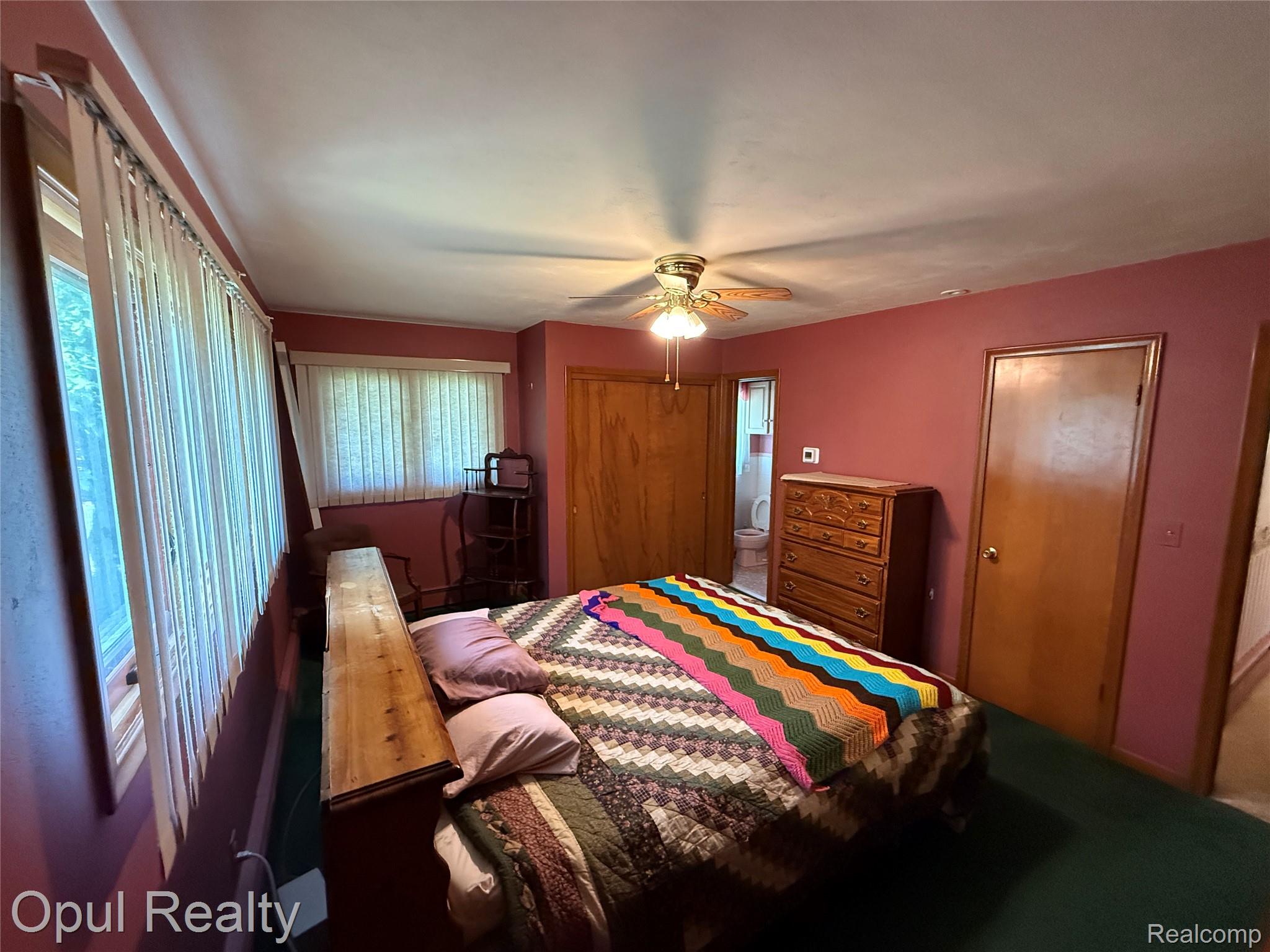 7899 Ida East Road Ida, MI 48140 - Photo 36 of 48 Room featuring wall-to-wall carpeting, multiple windows with blinds, a ceiling fan with integrated lighting, and solid wood interior doors