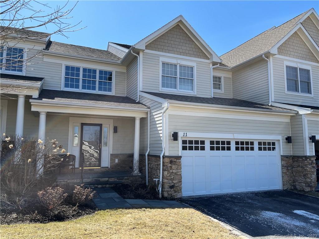 638 Danbury Road, Unit 11 Ridgefield, CT 06877 - Photo 1 of 1 a view of a house with a yard