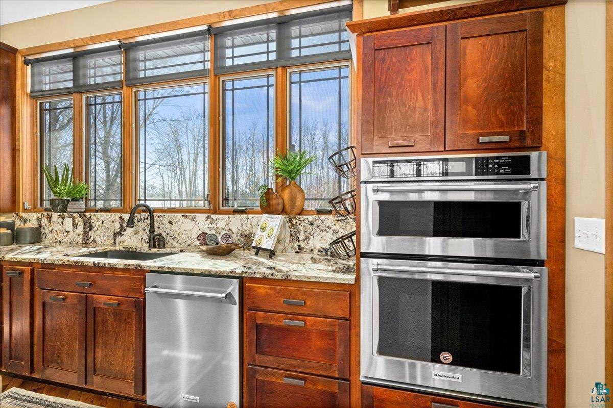 92598 Spells Road Sturgeon Lake, MN 55783 - Photo 17 of 60 Kitchen with stainless steel appliances, light stone countertops, and plenty of natural light