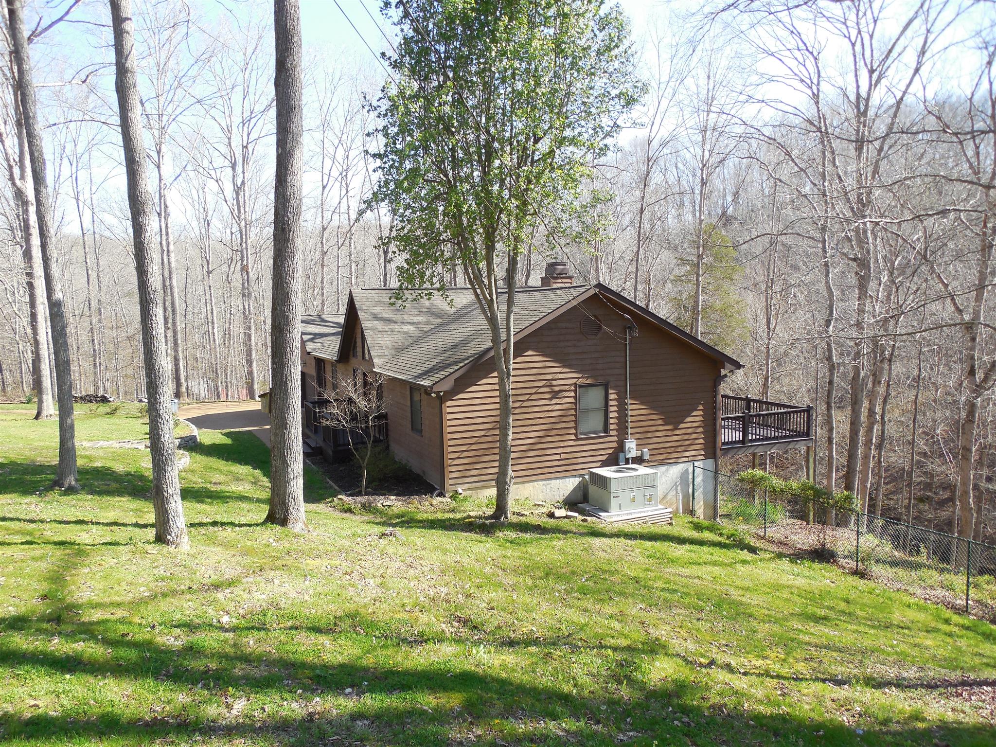 1235 Campbell Ridge Road Kingston Springs, TN 37082 - Photo 2 of 12 a backyard of a house with table and chairs