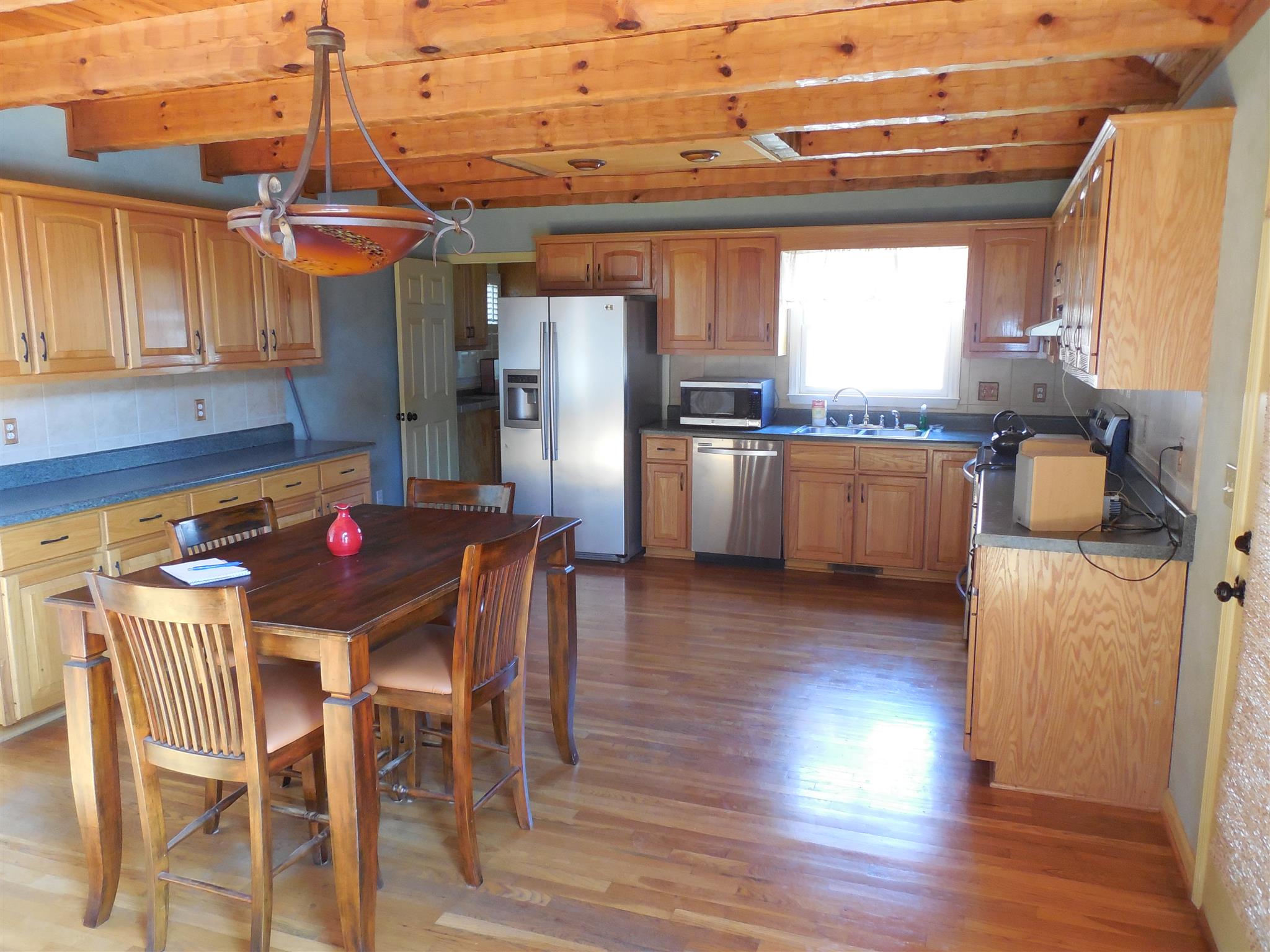 1235 Campbell Ridge Road Kingston Springs, TN 37082 - Photo 4 of 12 a kitchen with stainless steel appliances granite countertop a kitchen island hardwood floor and a sink