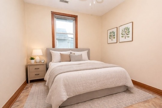 2128 West 24th Street, Unit 2 Chicago, IL 60608 - Photo 6 of 9 a large bed sitting in a bedroom next to a window