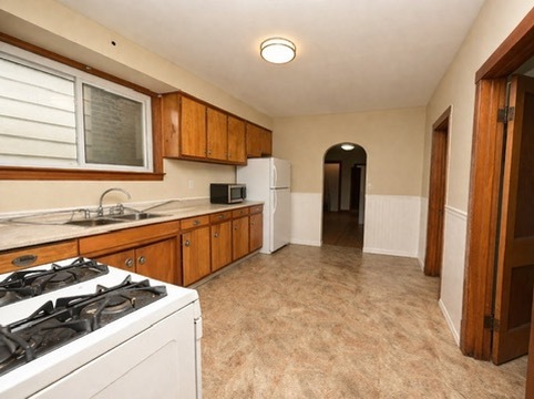 2128 West 24th Street, Unit 2 Chicago, IL 60608 - Photo 7 of 9 a kitchen that has a sink and a stove
