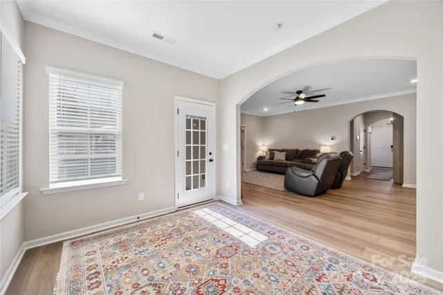 a large bed sitting in a room next to a window