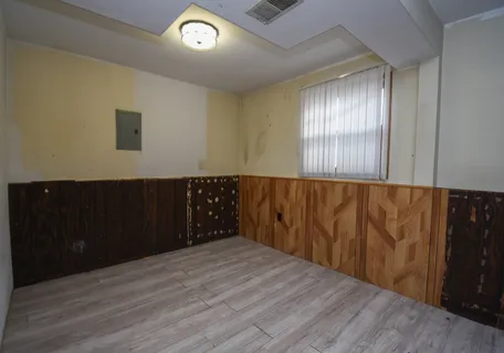 wooden floor in an empty room with a window
