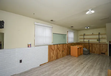 a view of kitchen with stainless steel appliances wooden floor