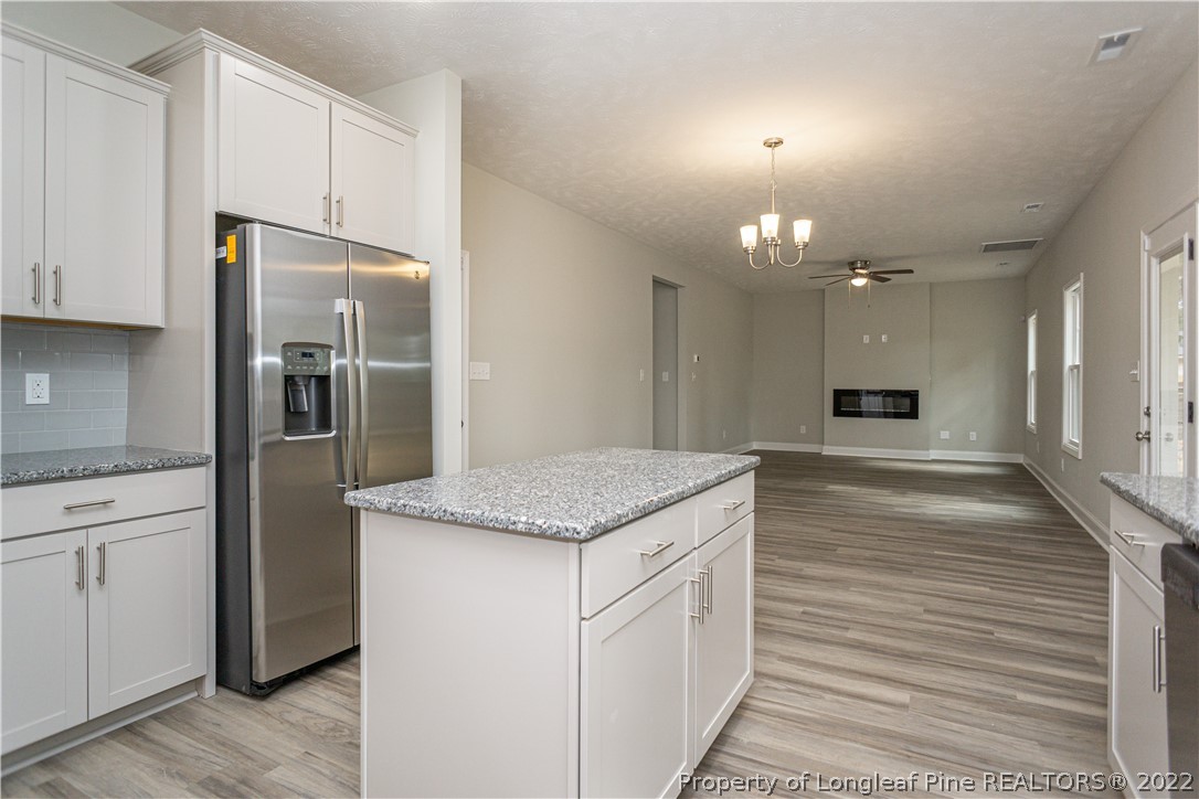 1628 Strickland Bridge Road Fayetteville, NC 28304 - Photo 11 of 34 a kitchen with stainless steel appliances granite countertop a refrigerator a oven and a sink with large cabinets
