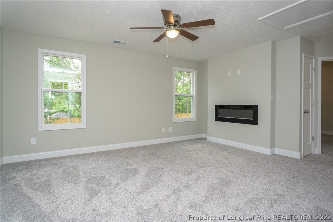 1628 Strickland Bridge Road Fayetteville, NC 28304 - Photo 18 of 34 an empty room with windows and fireplace